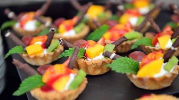 A dessert tray with fruit-topped tarts.