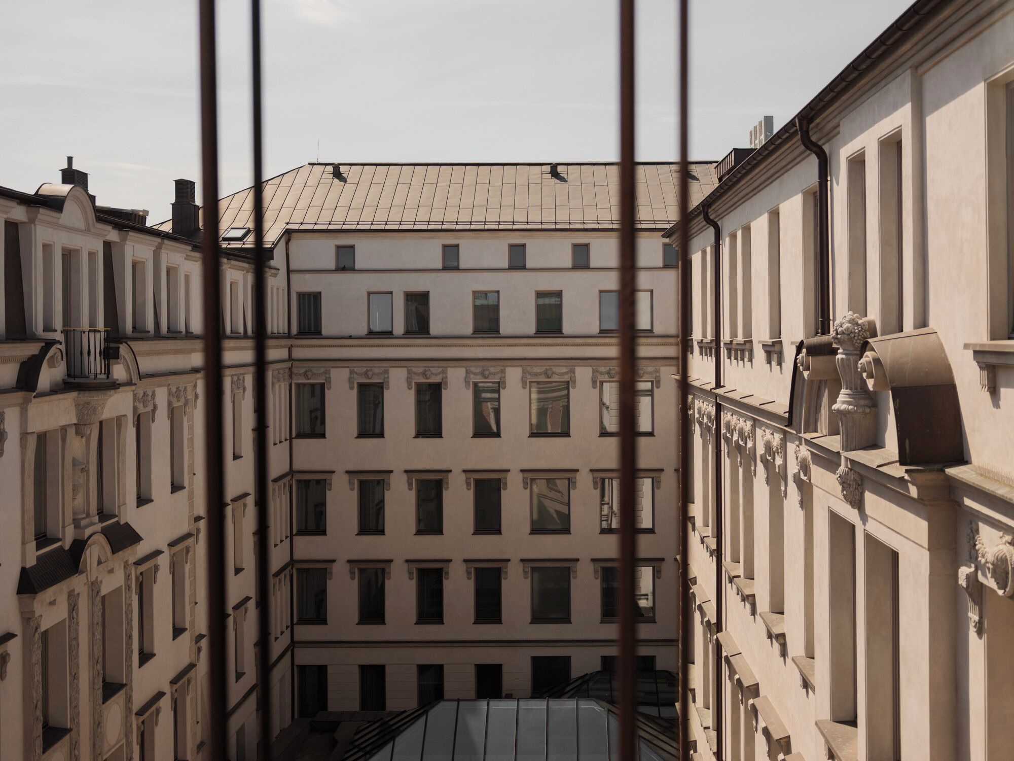 A multi-story building with a symmetrical facade, large windows, and classical architectural details.