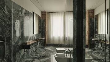 Une salle de bain moderne avec des murs en marbre, deux lavabos, une baignoire et un grand miroir.