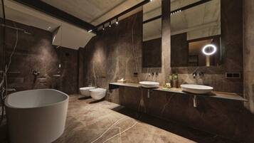 A modern bathroom with a large bathtub, two sinks, and a large mirror.