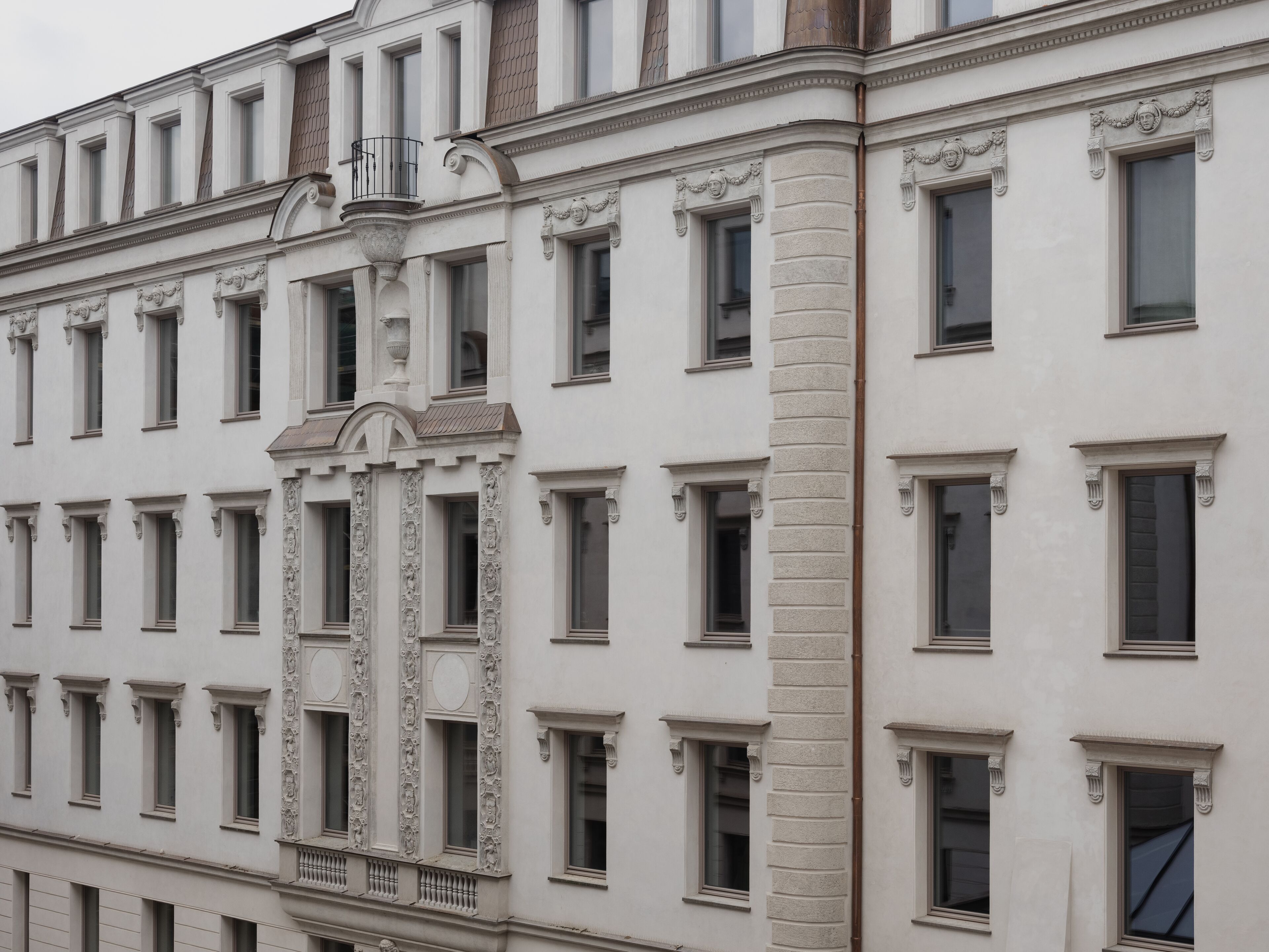 A building with a symmetrical facade, evenly spaced windows, and decorative stonework.