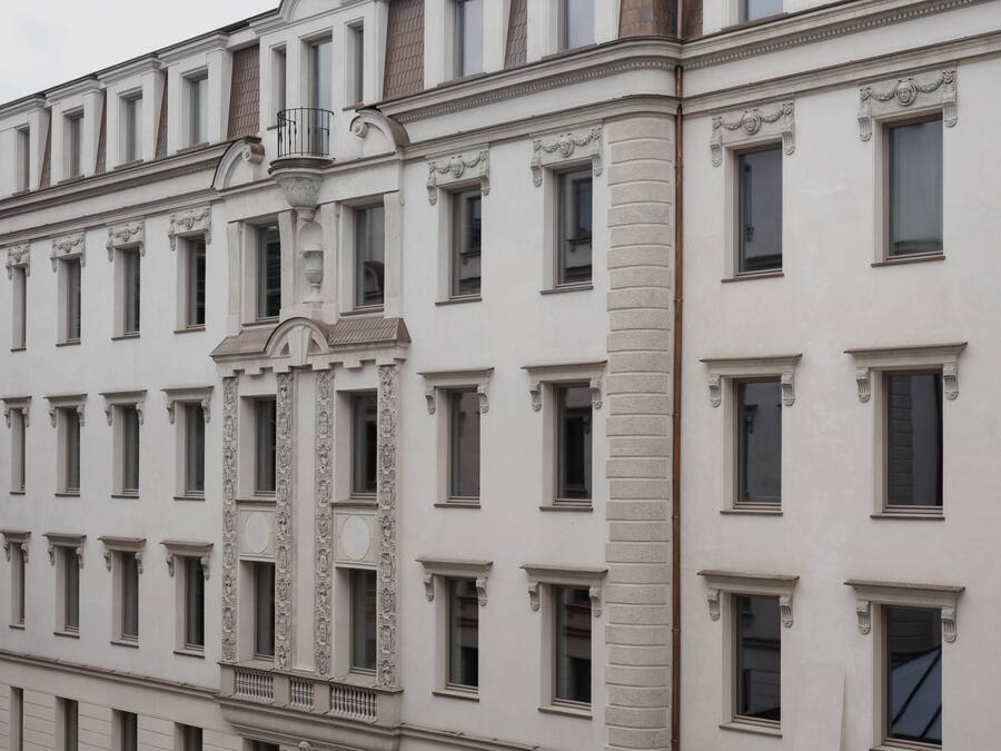 A building with a symmetrical facade, evenly spaced windows, and decorative stonework.