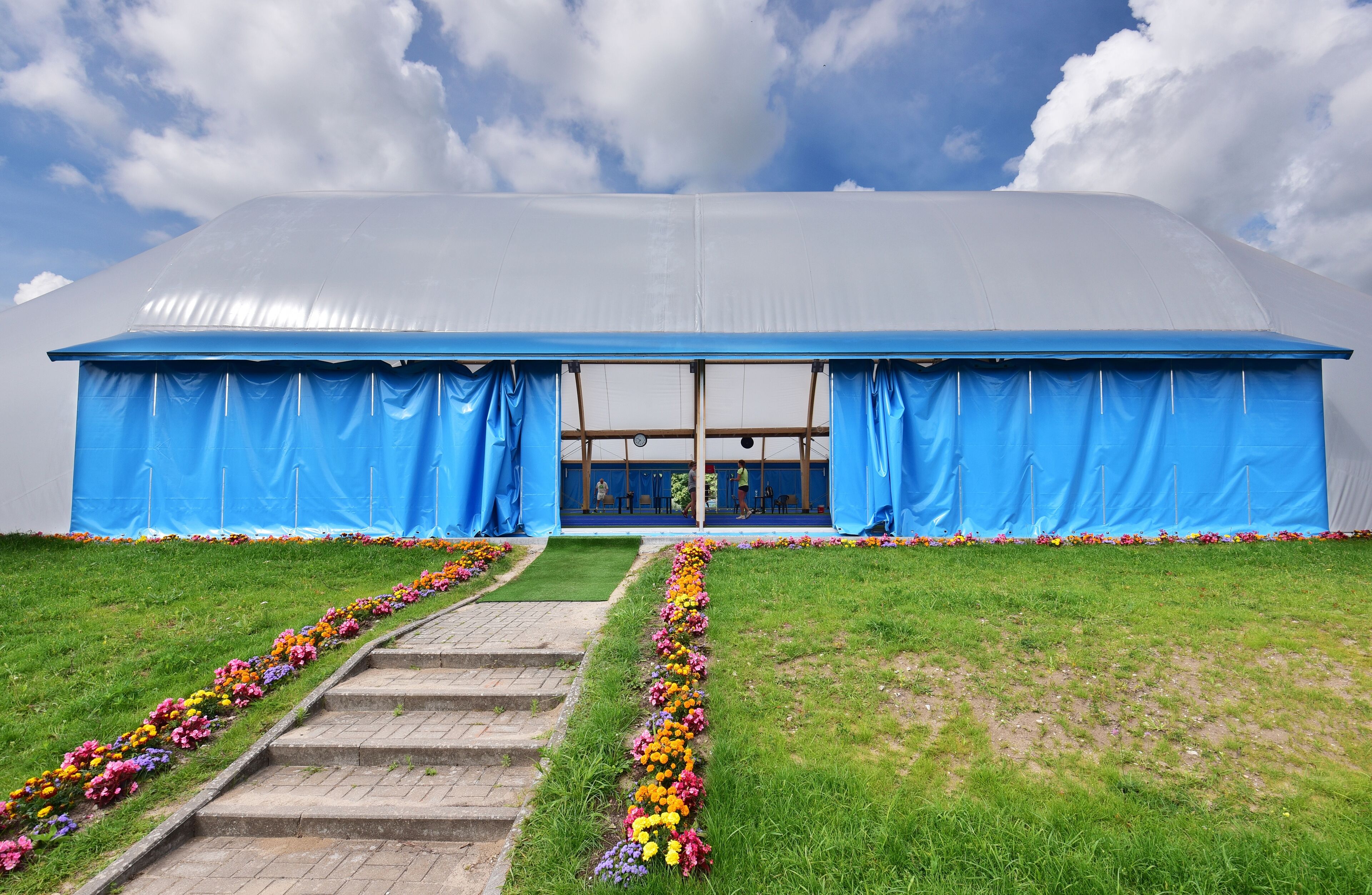 A large, covered structure with a blue roof and a central entrance.