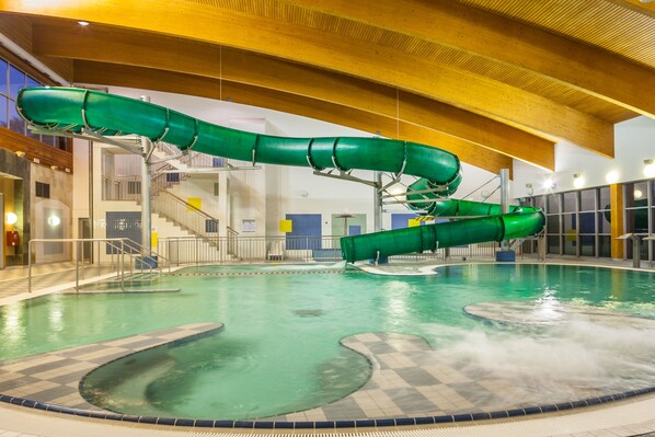 Enjoy a refreshing swim in our indoor pool, featuring a thrilling water slide and spacious deck.