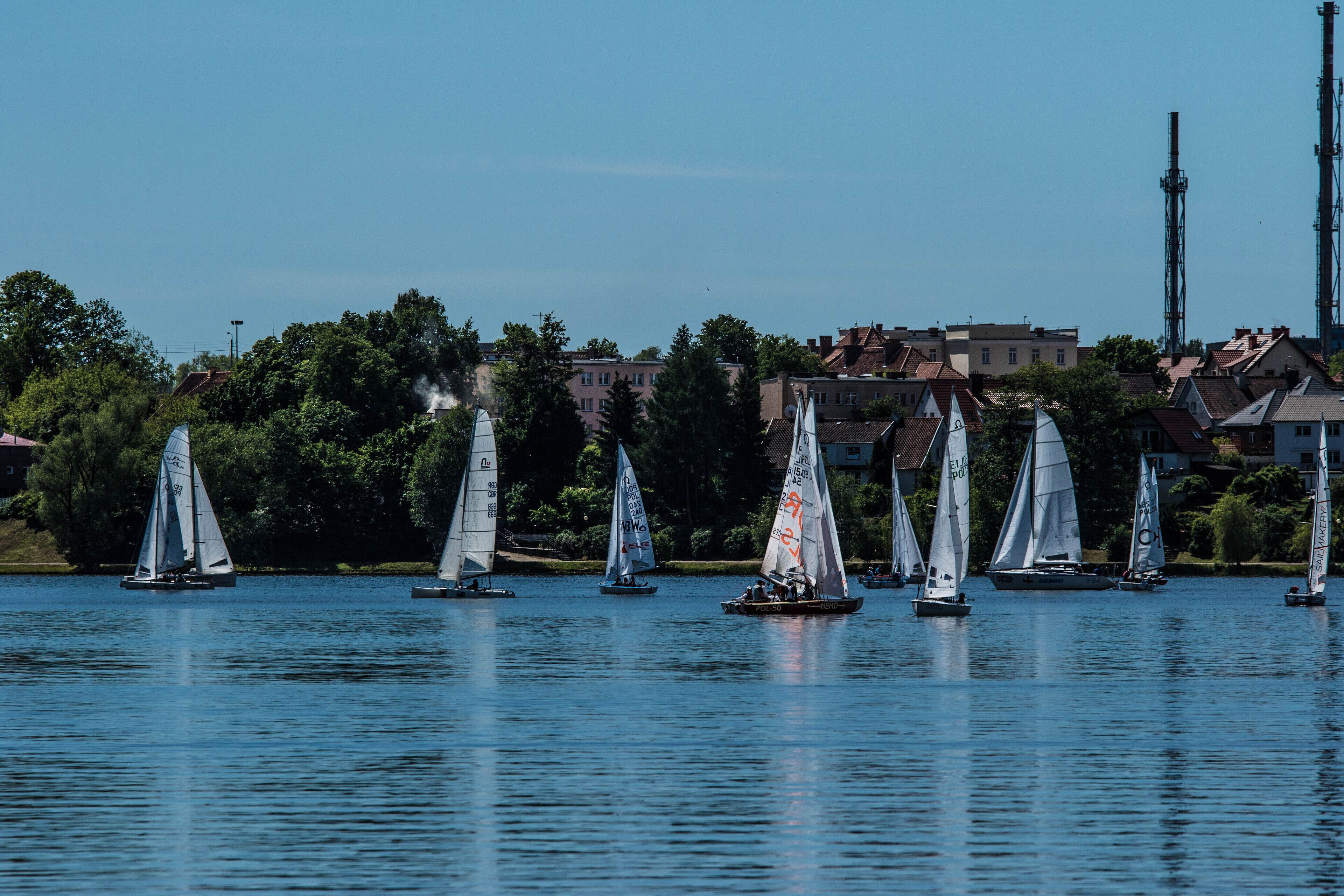 A calm lake with sailboats.