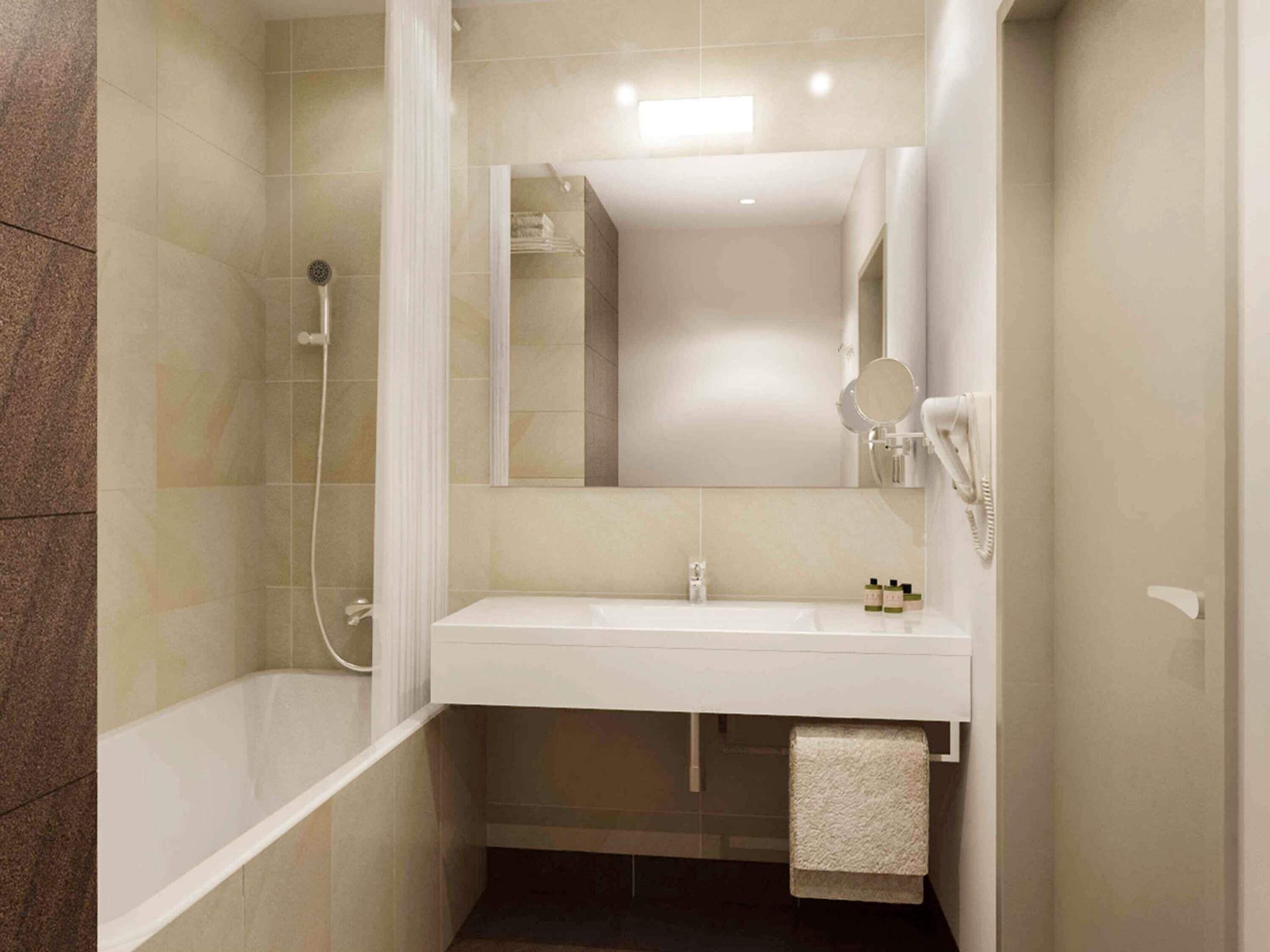 A modern bathroom with a bathtub, a sink, and a mirror.
