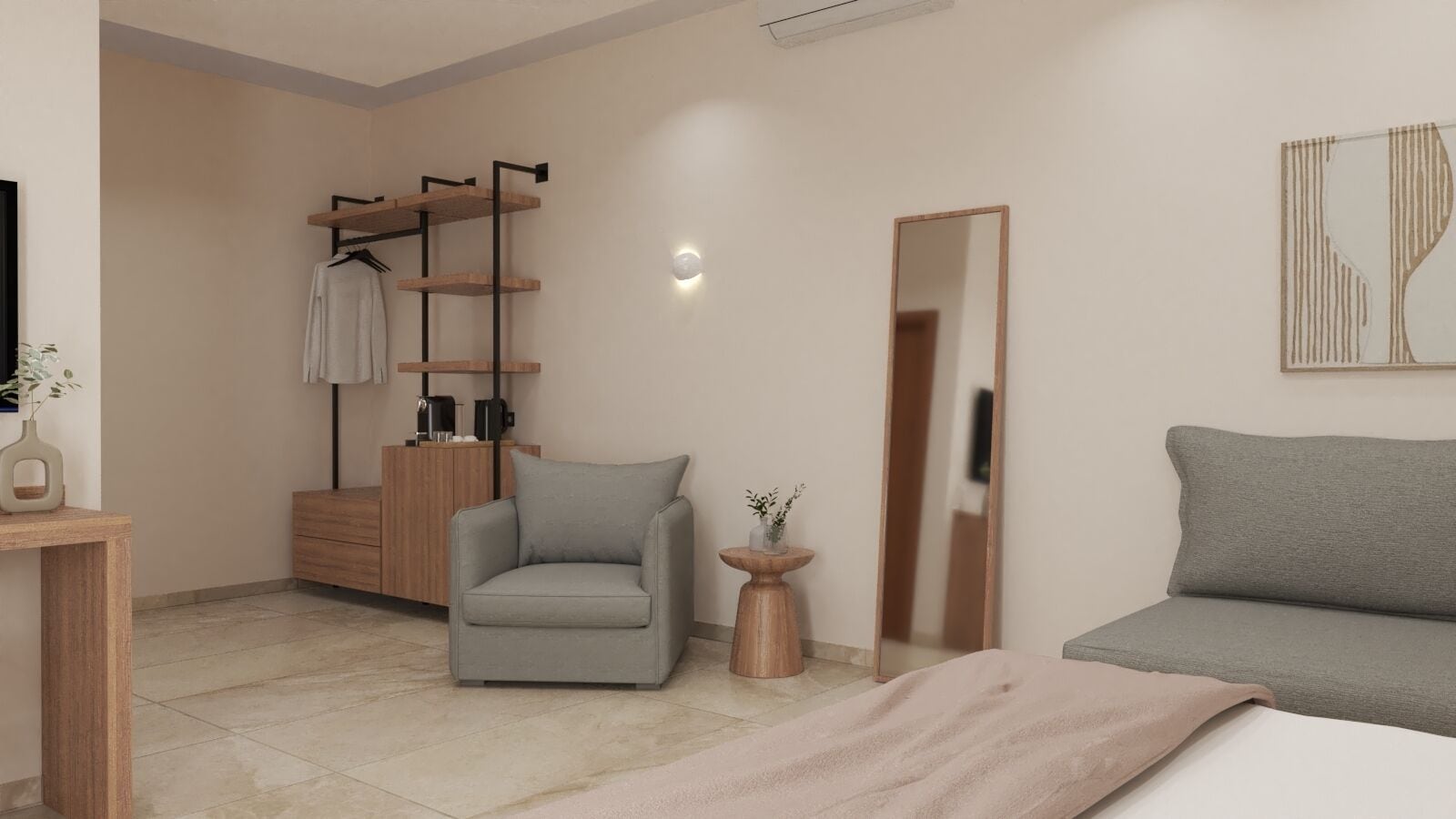 A modern bedroom with a grey sofa, a grey armchair, a wooden dresser, and a mirror.