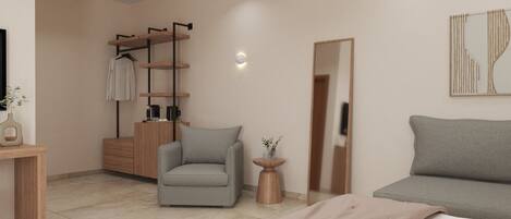 A modern bedroom with a grey sofa, a grey armchair, a wooden dresser, and a mirror.