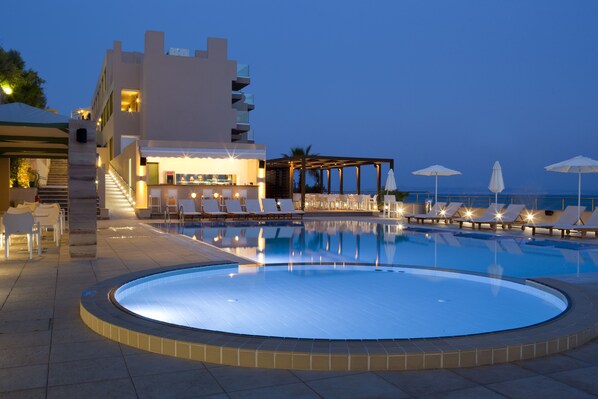 Relax by the pool surrounded by a lounge area with comfortable seating and scenic views.