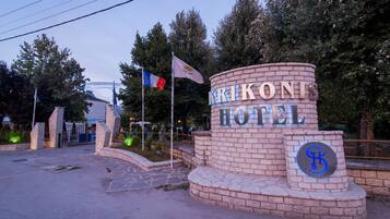 A brick entrance with the sign "KRIKONIS HOTEL" and a logo.