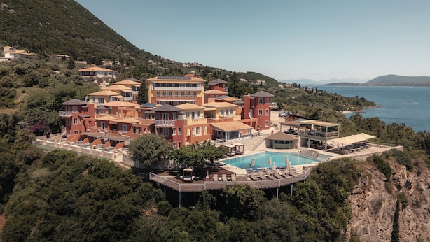 A coastal resort with multiple buildings, a swimming pool, and a view of the sea. - Red Tower (Lefkada)