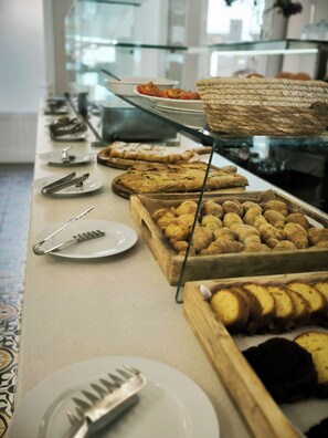 A buffet with various baked goods and pastries. - Red Tower (Lefkada)