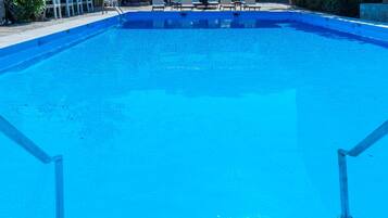 Seasonal outdoor pool, open 8:00 AM to 8:00 PM, pool loungers