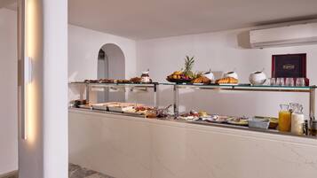 A buffet setup with various food items and condiments.