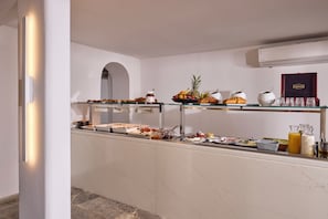 A buffet setup with various food items and condiments.