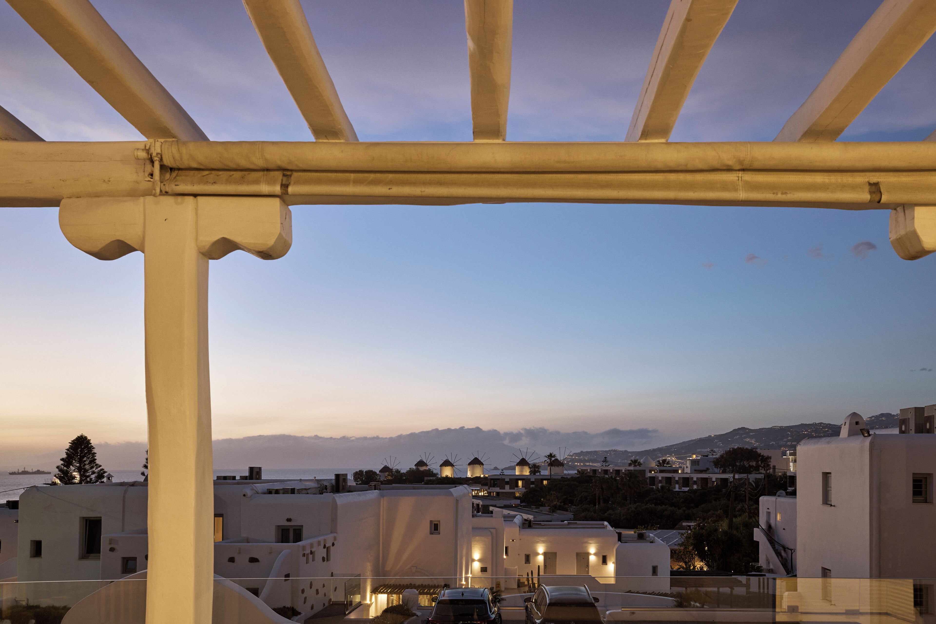 A coastal town with white buildings, a clear sky, and a view of the sea.