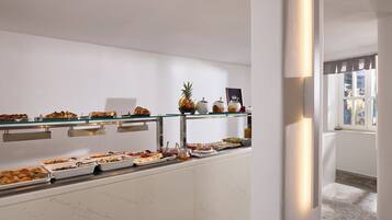 A buffet with various food items and a pineapple on display.