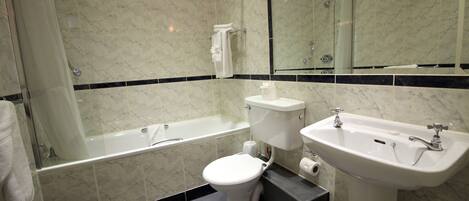 Un baño moderno con bañera, inodoro y lavamanos.