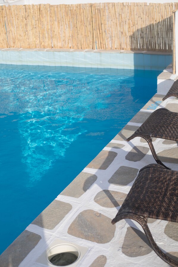 Seasonal outdoor pool, pool loungers