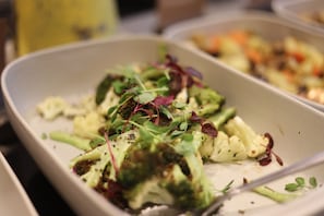 A close-up of a dish with broccoli and greens. - Inhabit Southwick Street, a Member of Design Hotels (London)