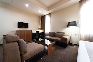 Deluxe Double Room | Living room | Flat-screen TV