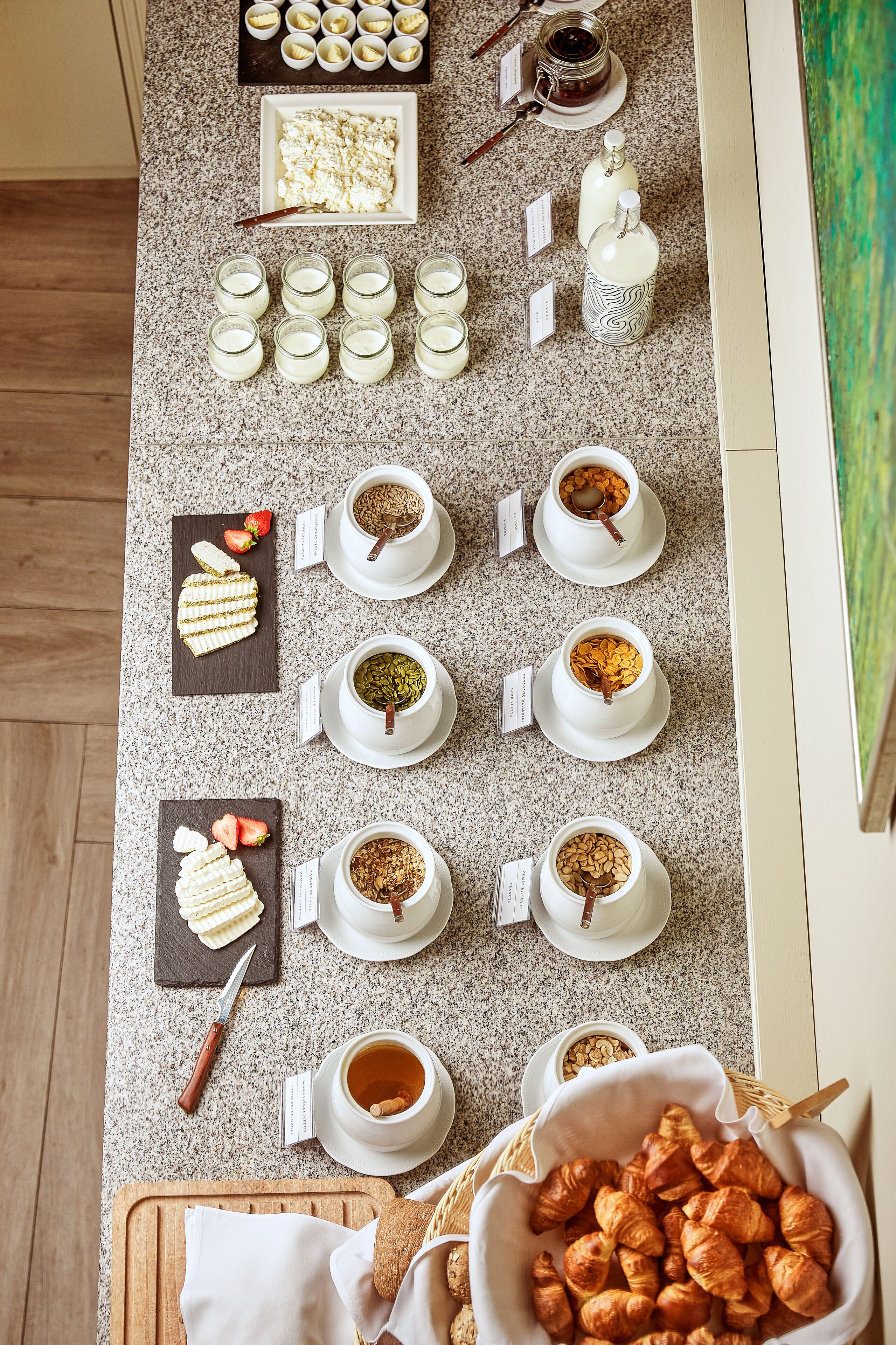 A breakfast buffet with various food items and beverages arranged on a countertop.