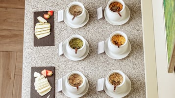 A breakfast buffet with various food items and beverages arranged on a countertop.
