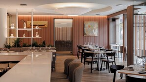 A modern restaurant interior with a bar area, dining tables, and chairs. - Hotel Kaunas (Kaunas)