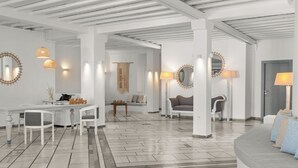 A modern interior with a dining area, seating, and a sofa.