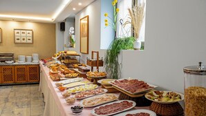 A buffet with various food items and a decorative plant.