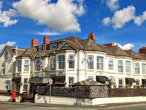 Stunning historic building with a classic facade, featuring a central entrance and decorative elements.