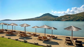 On the beach, sun-loungers, beach umbrellas, beach towels