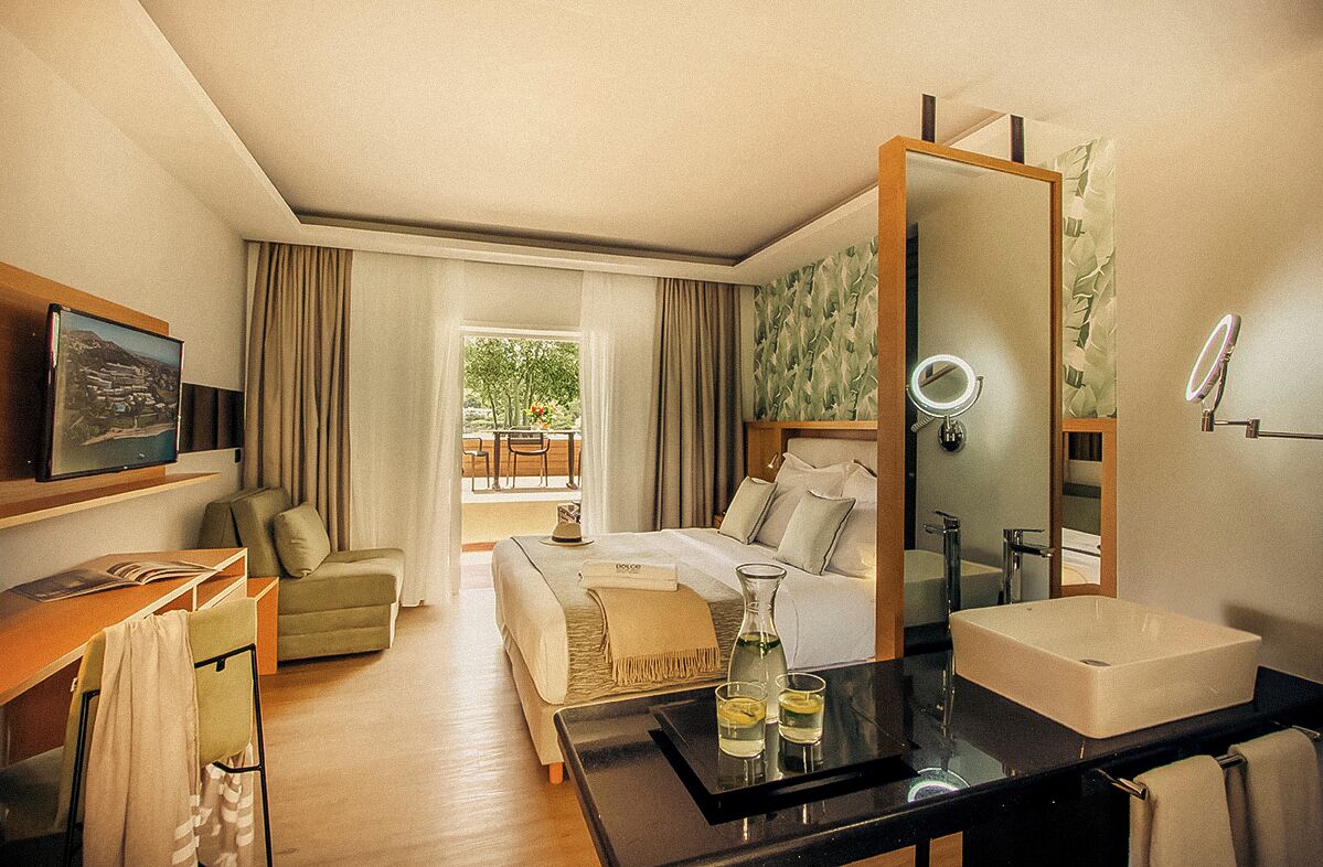 ميني بار وخزنة داخل الغرفة ومكتب وستائر تعتيم