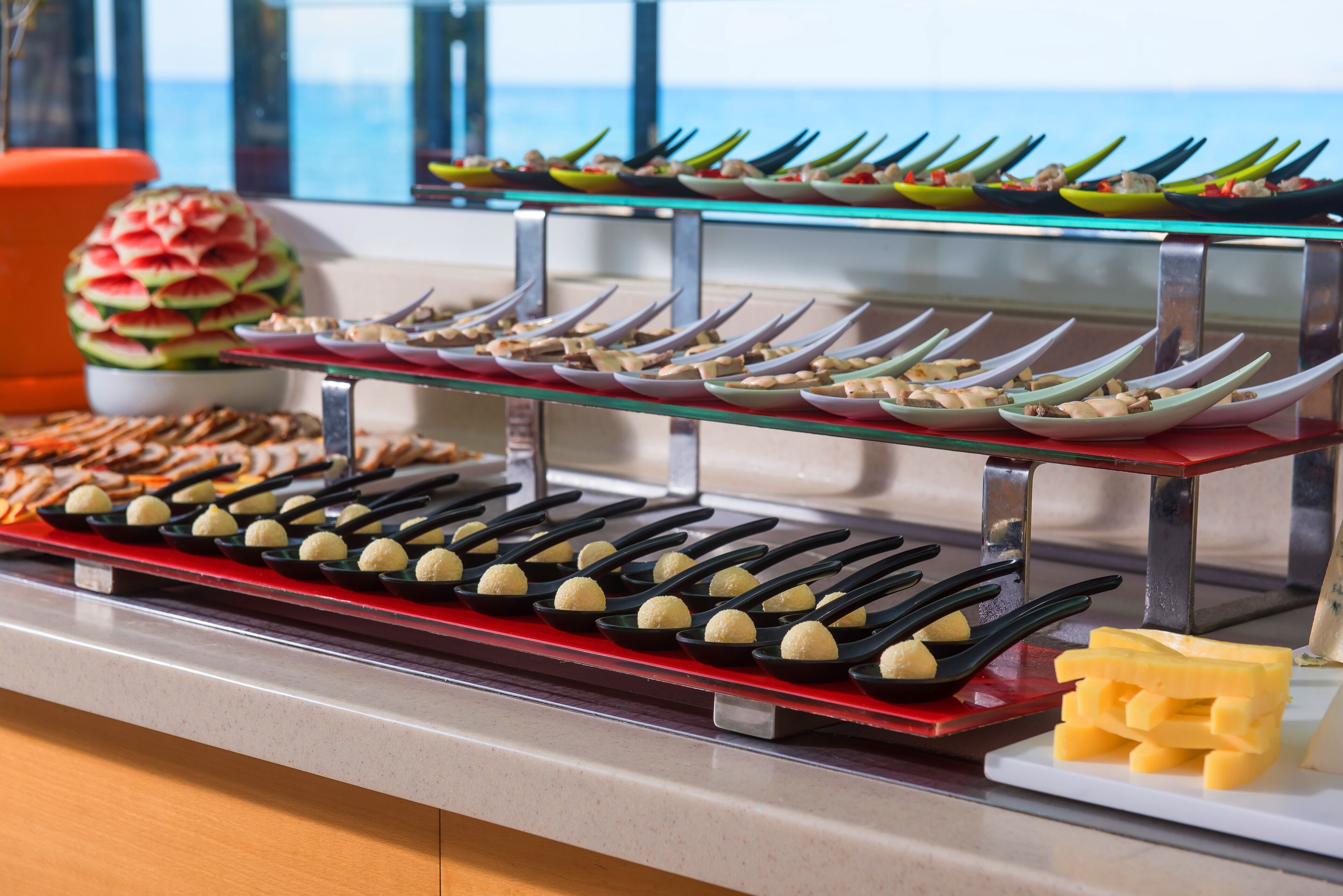 A buffet with various dishes and utensils.