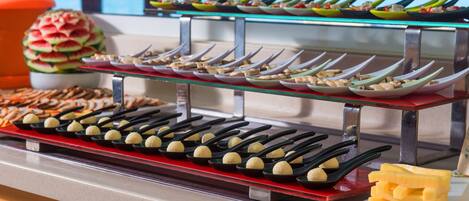 A buffet with various dishes and utensils.