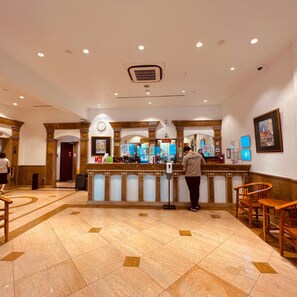 A hotel lobby with a reception desk, a clock, and a digital display. - Park View Hotel Singapore (Singapore)