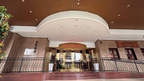 The entrance of Park View Hotel with a modern design, featuring a curved ceiling and a central entrance with glass doors.