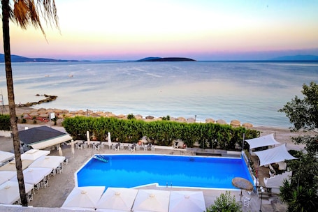 Seasonal outdoor pool, open 10:00 AM to 7:00 PM, pool umbrellas. The Grove Seaside Hotel