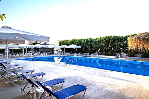 Seasonal outdoor pool, open 10:00 AM to 7:00 PM, pool umbrellas