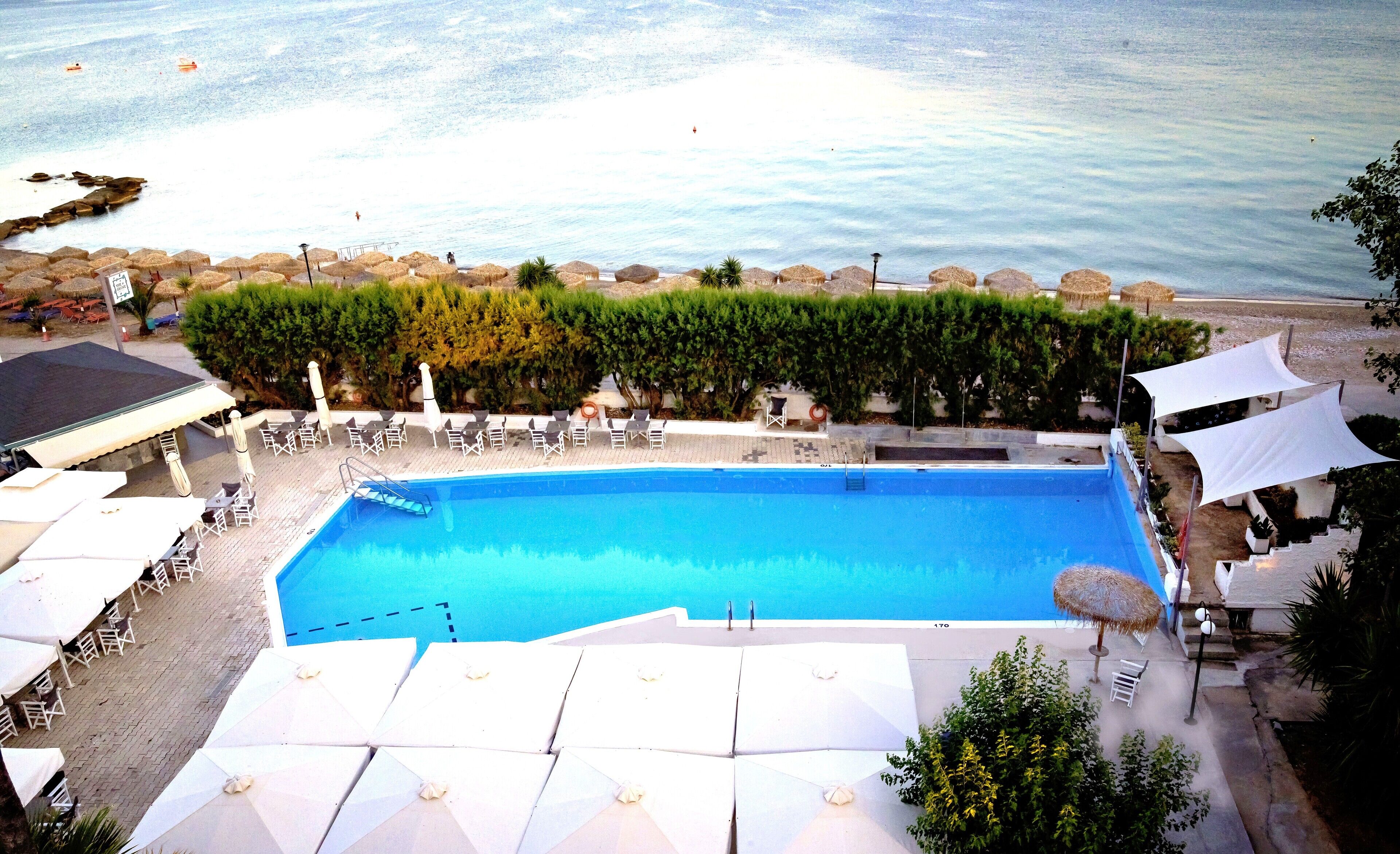 Seasonal outdoor pool, open 10:00 AM to 7:00 PM, pool umbrellas