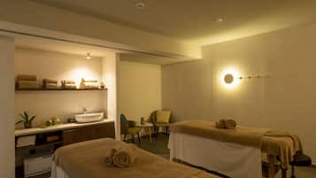 Relax in a serene spa room with a massage table, sink, and calming ambiance.