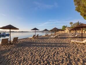 Beach nearby, white sand, beach towels, beach volleyball