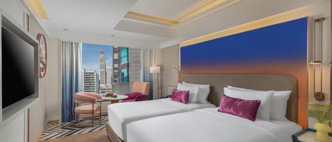 A hotel room with two beds, a TV, a desk, and a view of the cityscape.