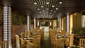 A restaurant with wooden furniture, a patterned ceiling, and a central counter. - Hilton Cairo Zamalek Residences (Cairo)