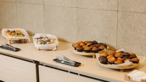 A buffet table with various food items and serving utensils. - Mimi Hotel Chisinau (Chisinau)