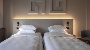A hotel room with two beds, a nightstand, a chair, and wall-mounted lighting. - Mimi Hotel Chisinau (Chisinau)