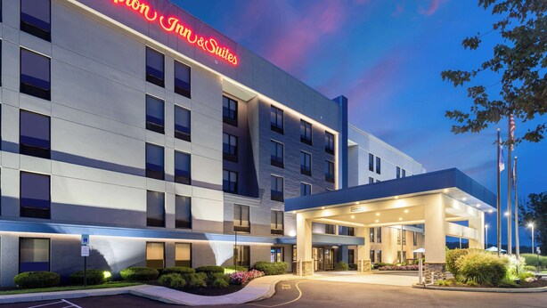 A modern hotel with a prominent sign reading "Hampton Inn & Suites." - Hampton Inn & Suites Valley Forge/Oaks (Phoenixville)