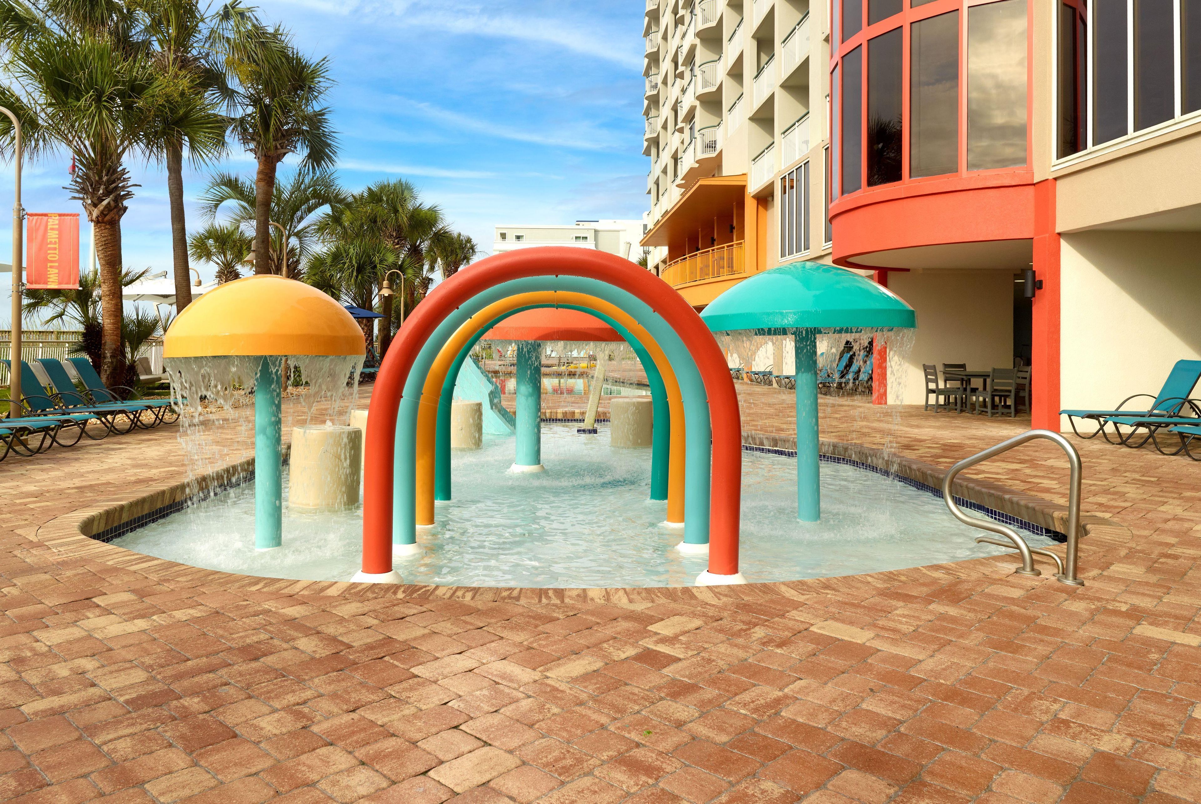 A water play area with colorful arches and a pool.