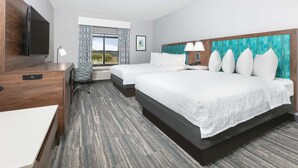 A hotel room with a large bed, a smaller bed, a desk, and a television. - Hampton Inn Santa Cruz (Santa Cruz)