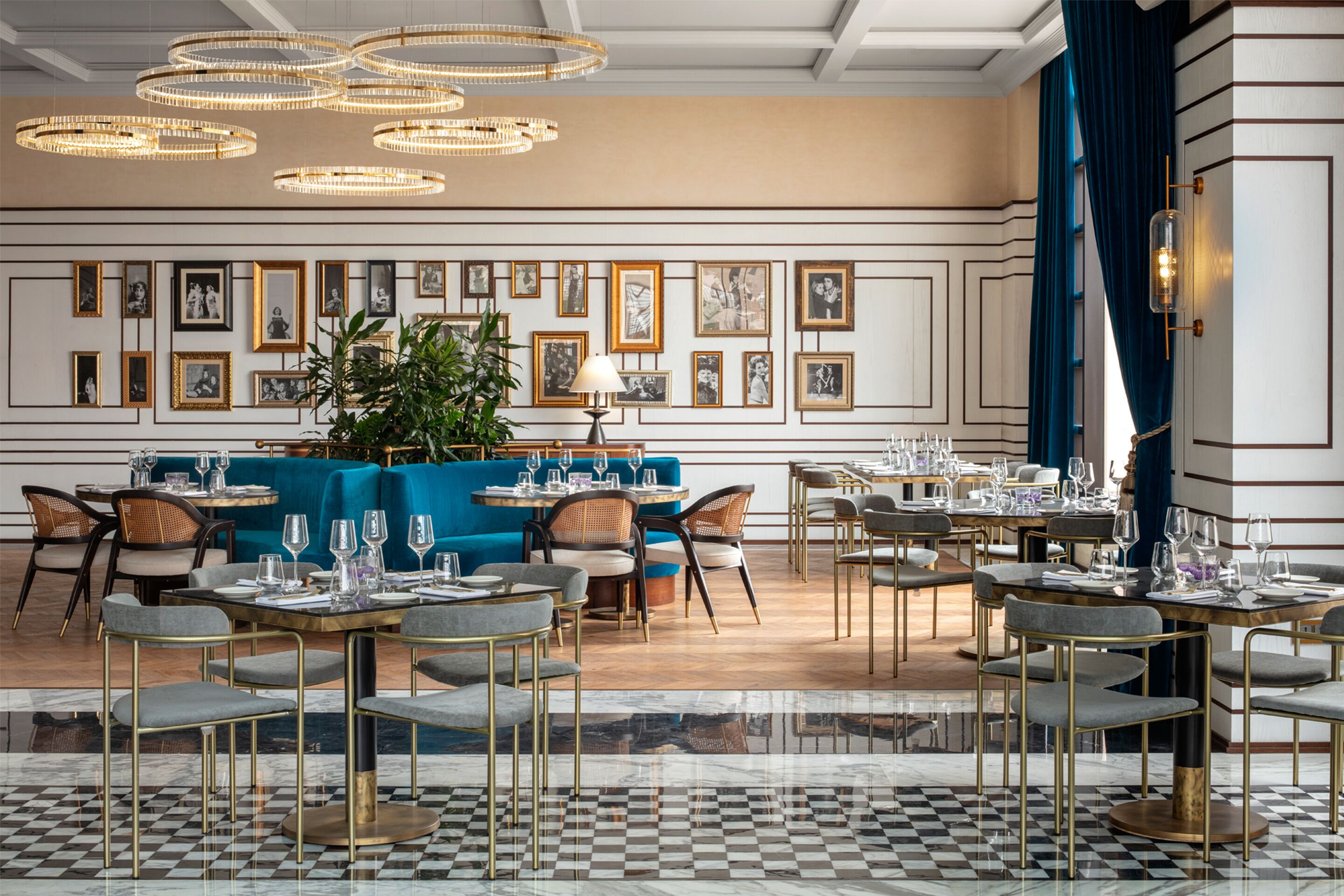 A dining area with round tables, chairs, and a checkered floor.